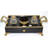 A Regency ebonised and brass standish