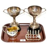 A silver toast rack, by Hukin and Heath, Birmingham, 1928; with two silver twin handled trophy