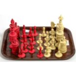 A carved and stained bone chess set, tallest piece 13cm