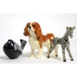 A Beswick pottery bird model by Colin Melbourne, together with a Beswick pottery spaniel and a Basil