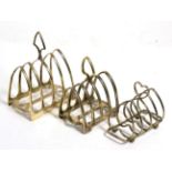 William Hutton & Sons Ltd silver four division toast rack; and two silver plated toast racks (3)