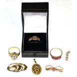 A 9 carat gold mouring ring, with a central shield shaped cartouche and the shank with plaques