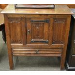 A joined oak cupboard, late 19th/early 20th century, carved overall with quatrefoil carving, the