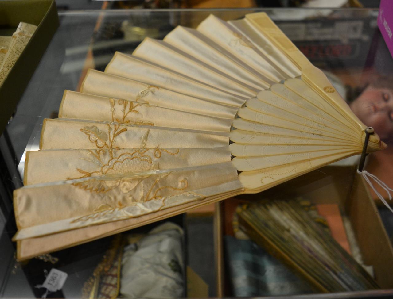 Circa 1860s bone fan, with pierced and carved guards and gorge, with a double fabric leaf,
