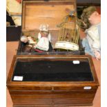 Dolls hinged trunk, circa 1950s clockwork group of two birds in a cage, assorted bisque, plastic and