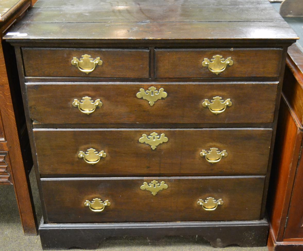 The top section of a George III oak chest on chest on associated base