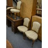 A set of four 19th century gilt and gesso dining chairs, recovered in cream floral striped fabric