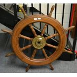 An oak and brass eight spoke ships wheel