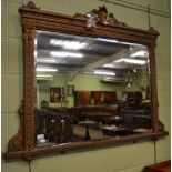 A gilt decorated over mantel mirror