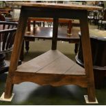 A 19th century pine cricket table with circular top and triangular shaped shelf