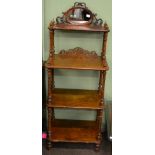 A Victorian walnut three tier etagere with mirrored surmount