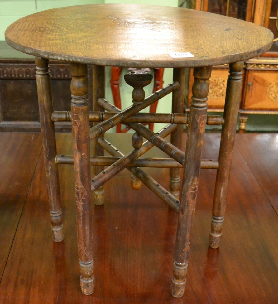 A 19th century inlaid oak circular occasional table with folding stand