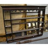 An 18th century dresser rack, with a dentil cornice above an arrangement of shelves and small