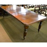 A Victorian mahogany extending dining table with two additional leaves