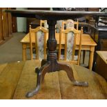 An 18th century oak flip top tripod table