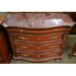 A reproduction serpentine fronted four height chest of drawers