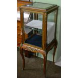 A gilt metal mounted display cabinet