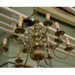 A Flemish style twelve light brass chandelier
