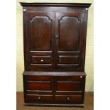 An 18th century panelled oak linen press converted to a wardrobe