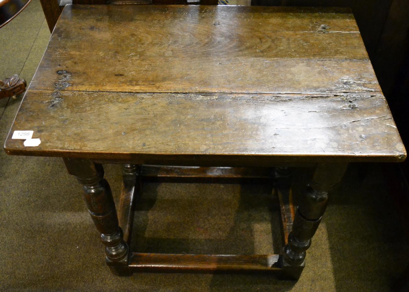 An oak side table with rectangular top raised on turned legs, 17th century in part