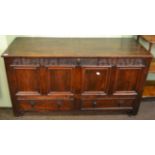 An 18th century oak four panelled coffer, fitted with two base drawers, containing a quantity of