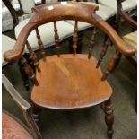 An early 20th century oak captain's chair