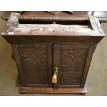 Carved oak double door cabinet enclosing one shelf