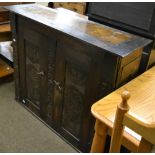 Carved oak cabinet enclosing two shelves