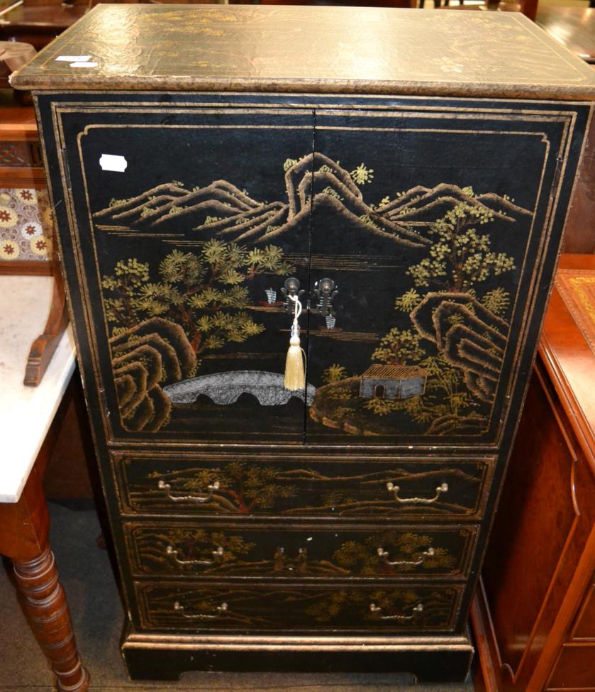 A 20th century ebonised and gilt decorated linen chest, decorated with Oriental figures and a