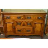 An early 20th century walnut and burr walnut sideboard