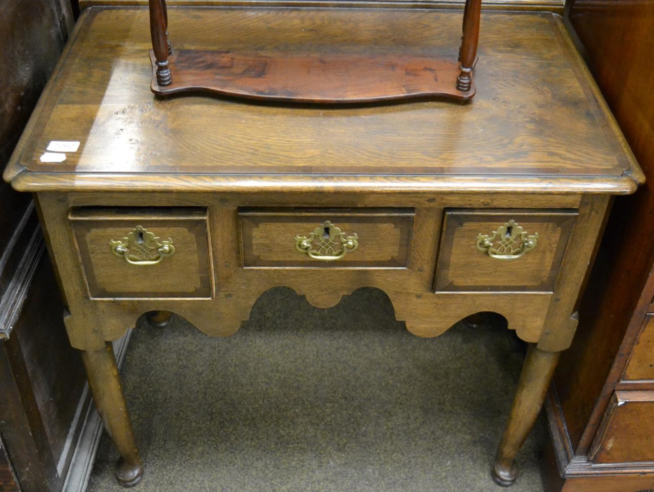 A reproduction oak and burr oak lowboy