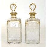 A pair of Daum cut glass decanters, with gilt decoration, gilt edged stoppers, signed Daum Cross