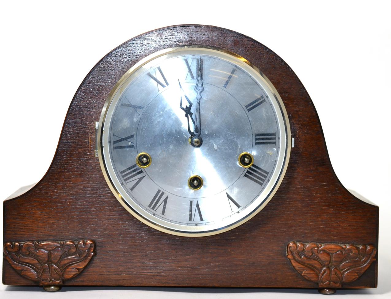 A 1920s Guta oak cased chiming mantel clock