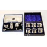 A set of six silver napkin rings, Chester 1922, in a fitted case; and a silver three piece condiment