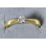 An 18 carat gold solitaire diamond ring, a round brilliant cut diamond in a claw setting, to knife