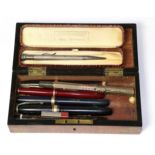 A Waterman gold cased fountain pen with calendar facility and six other gold nib fountain pens and a