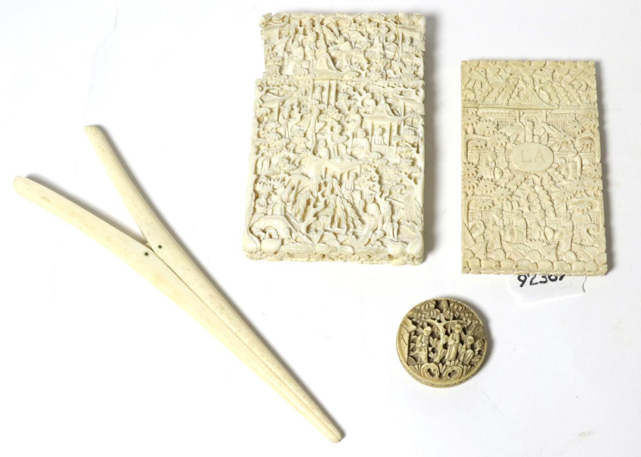 A Cantonese ivory card case; another; a small box; and glove stretchers, all circa 1900