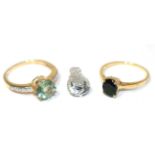 A 9 carat gold fluorite and white zircon ring, a round cut fluorite in a claw setting, to ziron