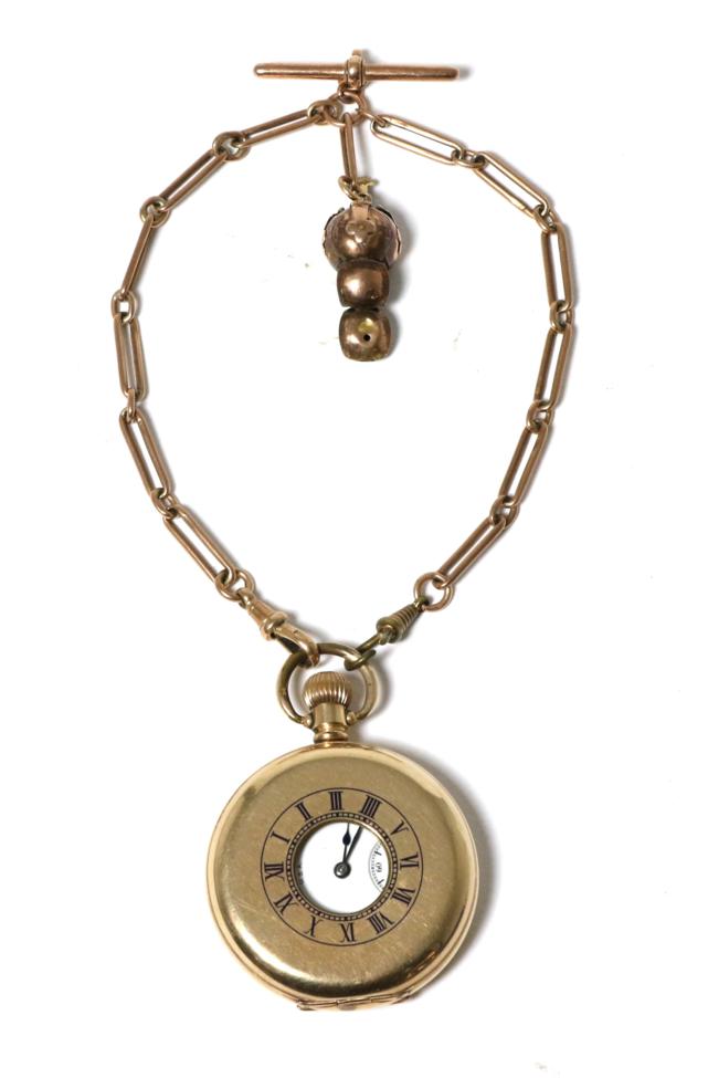 A gold plated half hunter pocket watch, signed Waltham, with a 9 carat gold watch chain and attached
