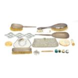 A silver backed mirror and three brushes with a Stratton compact and lipstick with other items (