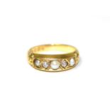 An 18 carat gold pearl and diamond ring, three pearls spaced by old cut diamonds in kite settings,