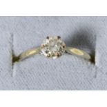 A solitaire diamond ring, a round brilliant cut diamond in a claw setting, to an extended under