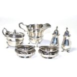 A pair of silver salts, a pair of silver pepperettes, a silver mustard and a cream jug, various