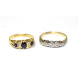 An 18 carat gold sapphire and diamond ring, three oval cut sapphires spaced by pairs of old cut