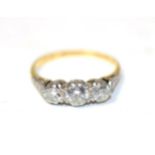 An 18 carat gold three stone diamond ring, graduated round brilliant cut diamonds in claw