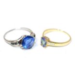 A 9 carat gold bi-colour tanzanite and diamond ring, an oval cut tanzanite in a claw setting, to