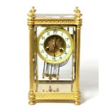 A gilt brass four glass striking mantel clock with a twin mercury tube pendulum, striking on a gong