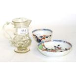 A Lowestoft porcelain tea bowl and saucer; and an 18th century glass jug (a.f.)