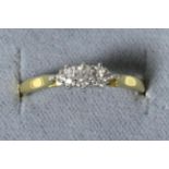 An 18 carat gold diamond ring, a round brilliant cut diamond to diamond set shoulders, total