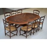 A Reproduction Oak Extending Dining Table, of circular form with two additional leaves, raised on